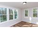 Bright bedroom with wood floor features multiple windows and nature views at 2504 S Cannon Blvd, Kannapolis, NC 28083