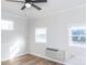 Bright bedroom with wood floors, ceiling fan, and window AC unit at 2504 S Cannon Blvd, Kannapolis, NC 28083