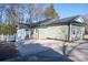 Back of house with a gravel area leading to a blue side entry door and a small white fence at 2504 S Cannon Blvd, Kannapolis, NC 28083
