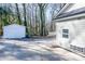 Side view of the home with a white detached garage and mature trees in the background at 2504 S Cannon Blvd, Kannapolis, NC 28083