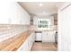 Bright kitchen featuring wood countertops, stainless steel appliances, and subway tile backsplash at 2504 S Cannon Blvd, Kannapolis, NC 28083
