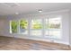 Open living room with hardwood floors, large windows and paneled walls at 2504 S Cannon Blvd, Kannapolis, NC 28083