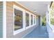 Covered porch features views of the landscape, with neutral paint and white window trim at 2504 S Cannon Blvd, Kannapolis, NC 28083