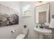 Small powder room with pedestal sink and geometric art at 3012 Sadler Woods Ln, Charlotte, NC 28214