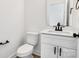 Simple white bathroom with single vanity and toilet at 3025 Swallowtail Ln, Kannapolis, NC 28083