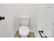 Simple, clean bathroom with white toilet and dark accents at 3025 Swallowtail Ln, Kannapolis, NC 28083