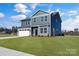 Gray house with white garage and stone accents at 3025 Swallowtail Ln, Kannapolis, NC 28083