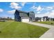 Two-story home with gray siding, white garage door, and landscaping at 3025 Swallowtail Ln, Kannapolis, NC 28083