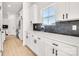 White kitchen with dark grey tile backsplash and lots of cabinet space at 3025 Swallowtail Ln, Kannapolis, NC 28083