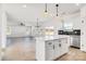 Open concept kitchen with white cabinets, island, and stainless steel appliances at 3025 Swallowtail Ln, Kannapolis, NC 28083