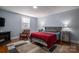Spacious bedroom with a comfortable bed, hardwood floors, and plenty of natural light at 408 Elizabeth St, Gastonia, NC 28054
