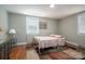 Charming bedroom with a floral quilt and ample natural light at 408 Elizabeth St, Gastonia, NC 28054