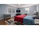 Comfortable bedroom with a red comforter and hardwood floors at 408 Elizabeth St, Gastonia, NC 28054