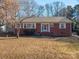 Brick ranch home with a welcoming front porch and yard at 408 Elizabeth St, Gastonia, NC 28054