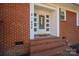 White front door entry with brick steps and welcome sign at 408 Elizabeth St, Gastonia, NC 28054