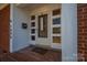 White front door entry with brick steps and welcome sign at 408 Elizabeth St, Gastonia, NC 28054