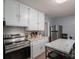 Updated kitchen with stainless steel appliances and white cabinetry at 408 Elizabeth St, Gastonia, NC 28054