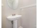 Small bathroom with pedestal sink and mirror at 5110 Osage Cir, Charlotte, NC 28269