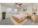 Cozy bedroom with natural light, ceiling fan, neutral walls, and stylish decor at 5110 Osage Cir, Charlotte, NC 28269