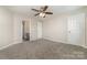 Bright bedroom with ceiling fan and carpet at 5110 Osage Cir, Charlotte, NC 28269