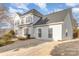 Two-story house with white siding, gray roof, and driveway at 5110 Osage Cir, Charlotte, NC 28269