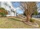 Landscaped front yard with trees and shrubs at 5110 Osage Cir, Charlotte, NC 28269
