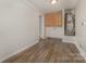 Laundry room with wood cabinets and flooring at 5110 Osage Cir, Charlotte, NC 28269