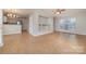 Open-concept living room features tile flooring, built-in shelving, and abundant natural light at 5110 Osage Cir, Charlotte, NC 28269