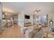 Inviting living room with tile floors, ceiling fan, large windows, and comfortable seating at 5110 Osage Cir, Charlotte, NC 28269