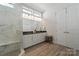 Spa-like bathroom featuring a walk-in shower and double vanity at 82112 Standing Oak Dr, Charlotte, NC 28278