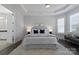Spacious primary bedroom with wood floors, large windows and a sitting area at 82112 Standing Oak Dr, Charlotte, NC 28278