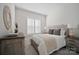 Spacious bedroom with a dresser, nightstands, and large window at 82112 Standing Oak Dr, Charlotte, NC 28278