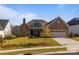 Inviting two-story home with stone accents and landscaped lawn at 82112 Standing Oak Dr, Charlotte, NC 28278
