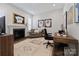 Cozy home office with fireplace, built-ins and large windows at 82112 Standing Oak Dr, Charlotte, NC 28278