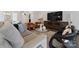 Comfortable living room featuring a plush sofa and stylish armchairs at 82112 Standing Oak Dr, Charlotte, NC 28278