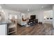 Open living room with hardwood floors and access to the kitchen and bedrooms at 82112 Standing Oak Dr, Charlotte, NC 28278