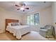 This bedroom features a cozy atmosphere with a ceiling fan and natural light from the beautiful set of windows at 92 Heritage Dr, Clover, SC 29710