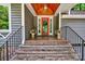 Inviting covered entryway with a red door and brick steps at 92 Heritage Dr, Clover, SC 29710