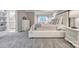 Bright main bedroom boasts neutral colors, plush carpet, and adjacent ensuite bathroom at 92 Heritage Dr, Clover, SC 29710