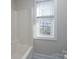 Clean bathroom featuring a shower/tub combo and a window at 9451 Bonnie Briar Cir, Charlotte, NC 28277