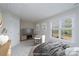 Virtually staged bedroom with a large window and a view of the backyard at 9451 Bonnie Briar Cir, Charlotte, NC 28277