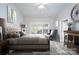 Virtually staged bedroom with large bed and window at 9451 Bonnie Briar Cir, Charlotte, NC 28277