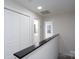 Upstairs hallway with dark wood accent wall and access to bedrooms and bathroom at 9451 Bonnie Briar Cir, Charlotte, NC 28277