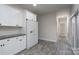 Kitchen features white cabinets, granite countertops, and tile flooring at 9451 Bonnie Briar Cir, Charlotte, NC 28277