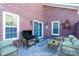 Outdoor patio space with brick walls, stylish furniture, and a grill at 9451 Bonnie Briar Cir, Charlotte, NC 28277