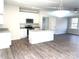 Open concept kitchen with island and wood-look flooring at 115 Venus Ave, Gastonia, NC 28052