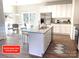 Modern kitchen with island, stainless steel appliances, and granite countertops at 115 Venus Ave, Gastonia, NC 28052