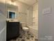 Modern bathroom with tub shower, vanity, and patterned tile floor at 1225 E 34Th St # Csw0419, Charlotte, NC 28205
