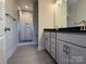 Double vanity bathroom with gray cabinets and a walk-in shower at 1225 E 34Th St # Csw0419, Charlotte, NC 28205