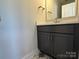 Modern bathroom with dark vanity, white countertop, and patterned tile floor at 1225 E 34Th St # Csw0419, Charlotte, NC 28205
